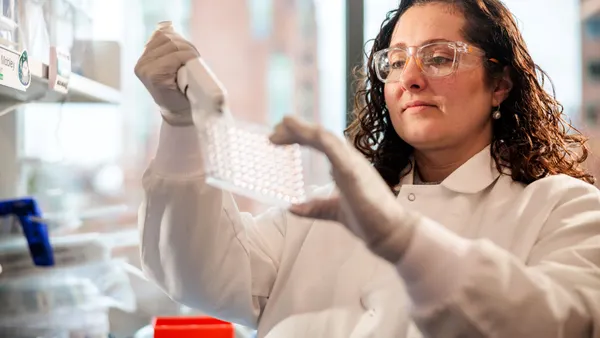 A scientist works in a laboratory to prepare samples for experiments.