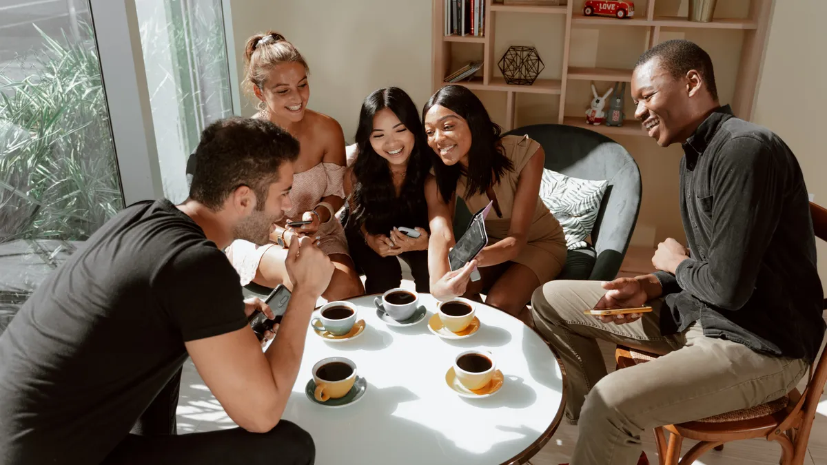 A group of employees enjoy coffee and take selfies