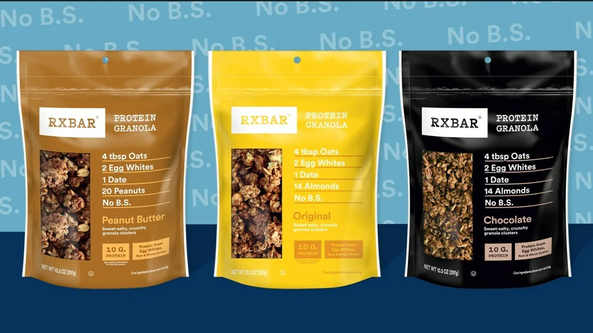 Three pouches of RXBar Granola sit on a surface with a blue background reading "No B.S." behind them.