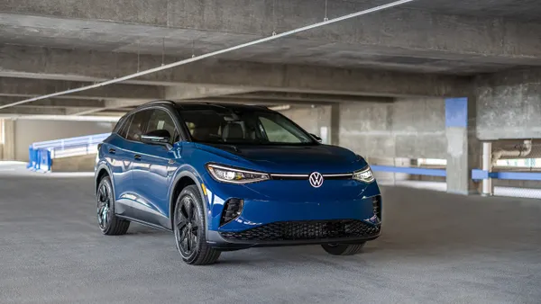 A 2025 ID.4 electric SUV with available Black Package inside a concrete parking garage.