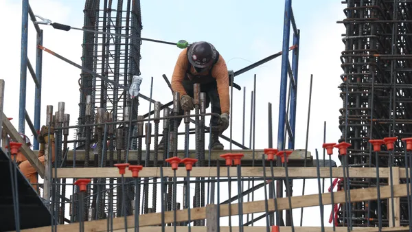 Construction workers help build a condo tower using steel rebar on Feb. 10, 2025, in Miami, Fla.