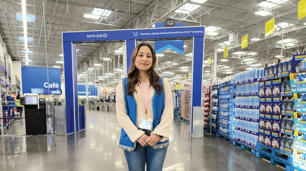 A person in front of shopping cart scanners in a store