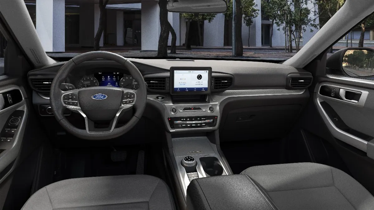 An interior view of the 2020 Ford Explorer SUV showing the dashboard with display for the backup cameras mounted in the center.