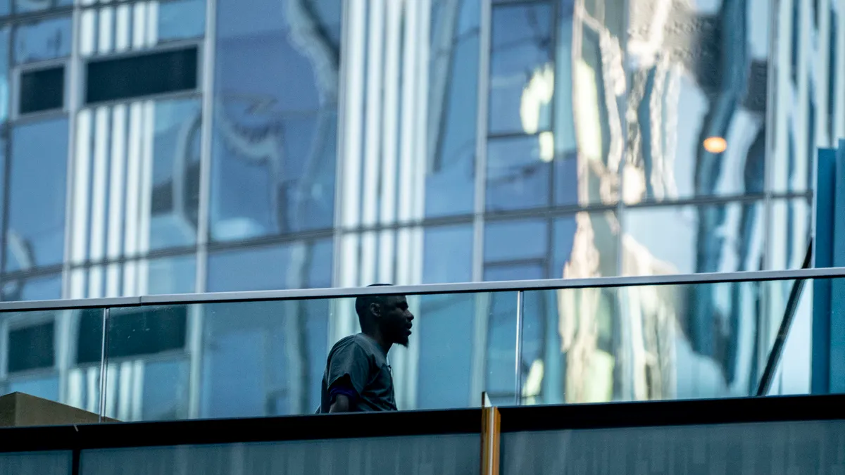 A person walks between buildings at the Amazon.com Inc. headquarters.