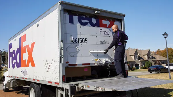 A parcel carrier worker opening a freight truck.