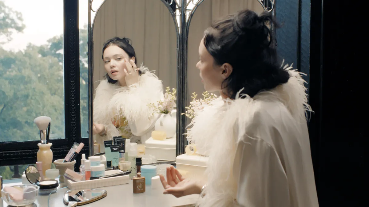 Musician Charlotte Rose Benjamin applies makeup in an E.l.f. video