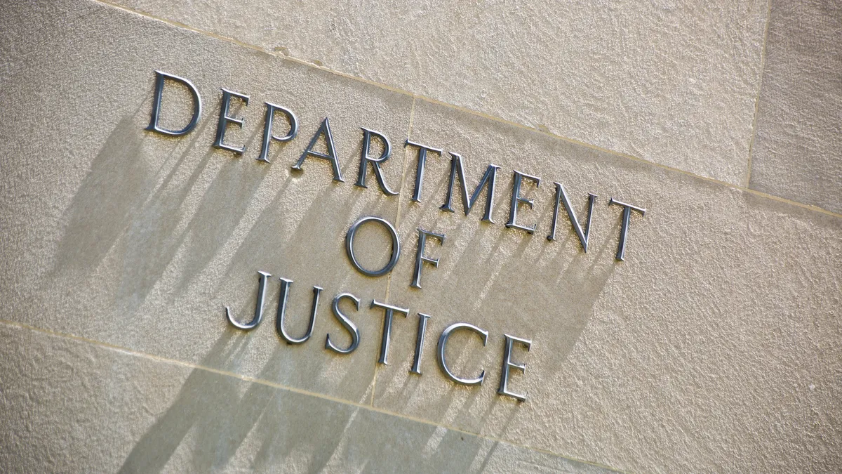 The entrance signage for the United States Department of Justice Building.