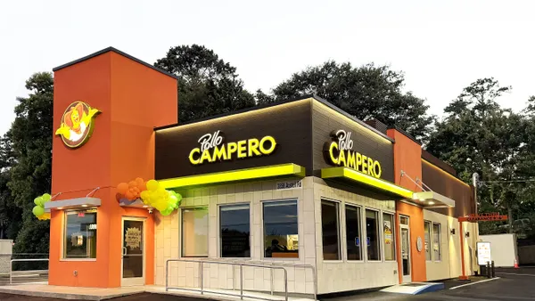 A orange and yellow storefront with Pollo Campero signage