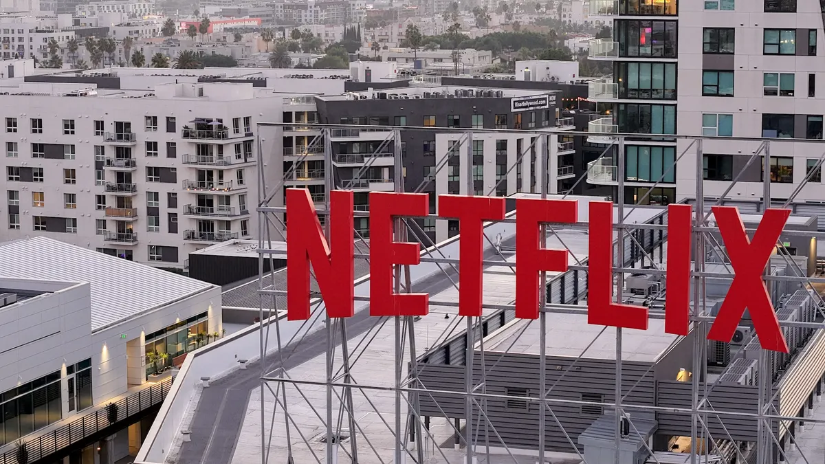In an aerial view, the Netflix logo is displayed above Netflix corporate offices.