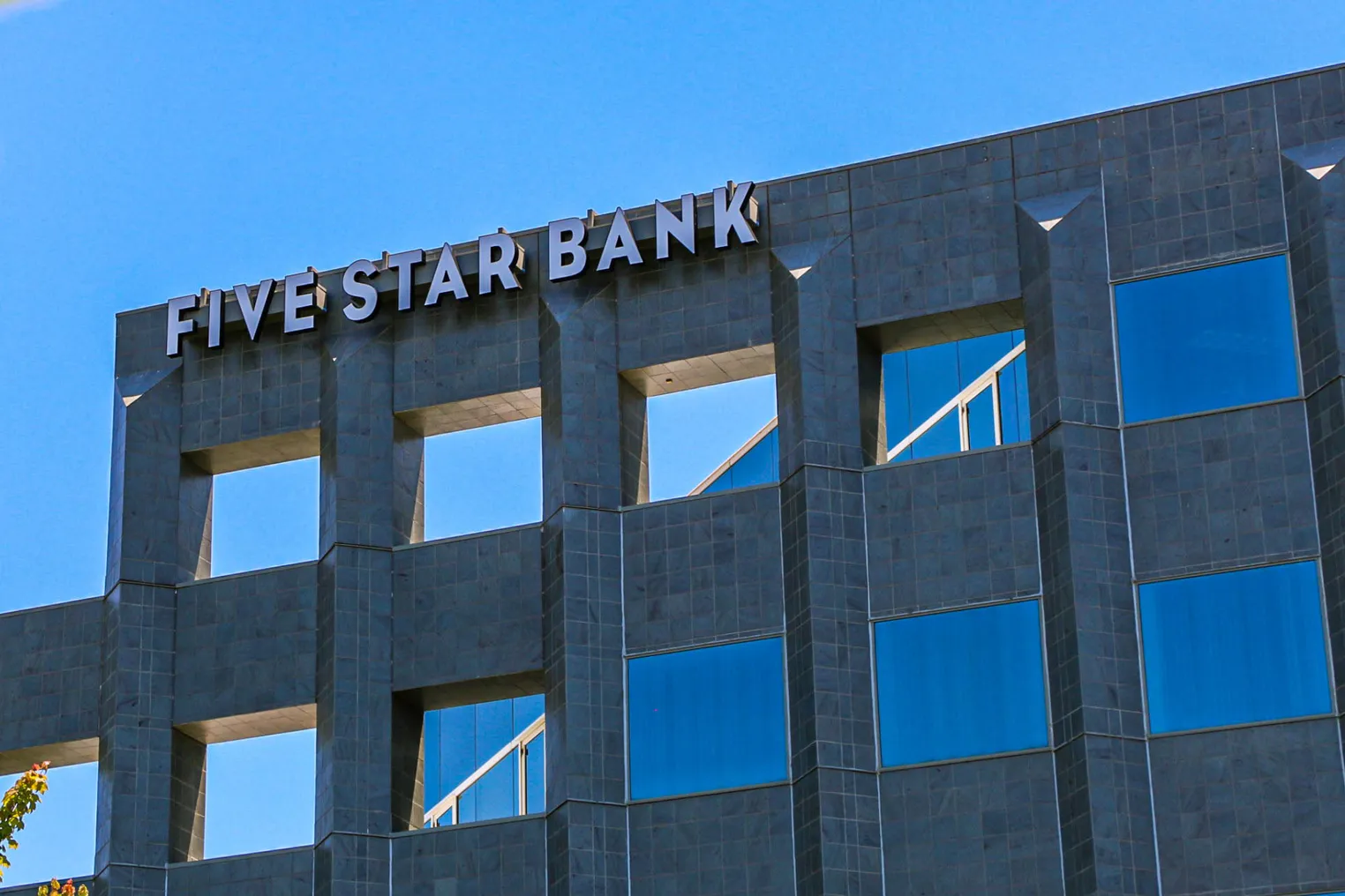 The exterior of Five Star Bank's Rancho Cordova office building is shown, with "Five Star Bank" in white letters at the top left of the building exterior.