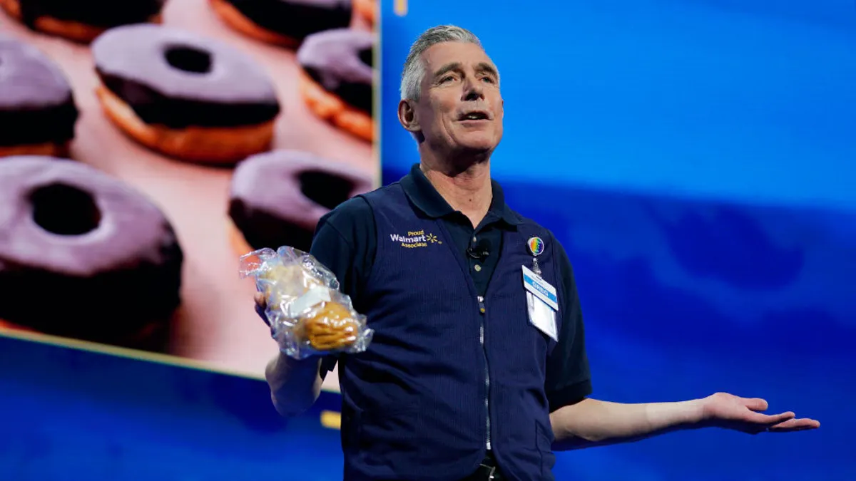 A person speaking at a company meeting.