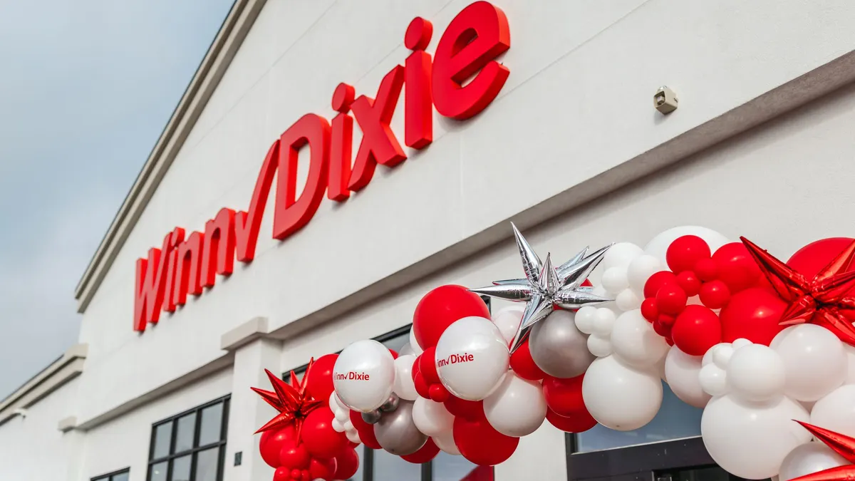 Exterior of Winn-Dixie grocery store on opening day with balloon arch