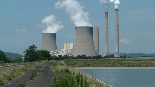 An electric power plant with cooling towers and smoke stacks.