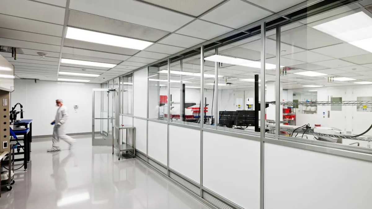 Technician walking around a manufacturing lab