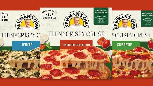 Three boxes of Newman's Own pizza are lined up in a row.