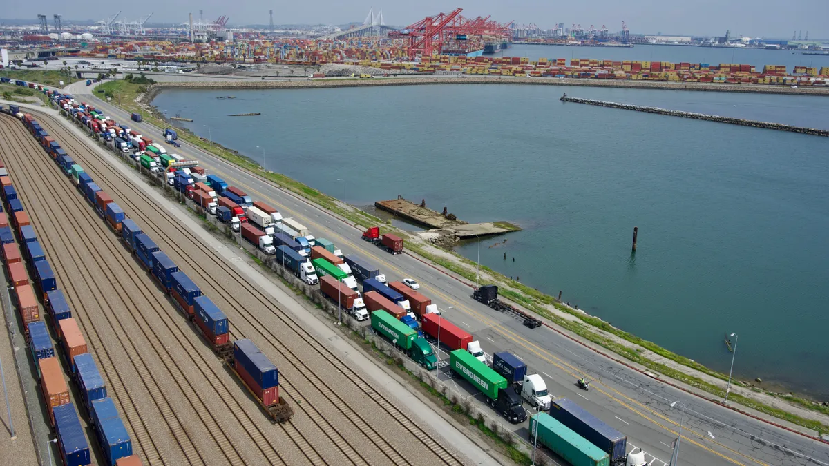 Trucks line up to enter the Fenix Marine Terminal at the Port of Los Angeles on Friday, March 17.