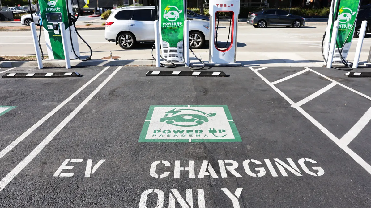 A parking space painted with "EV charging only" with a charger behind it