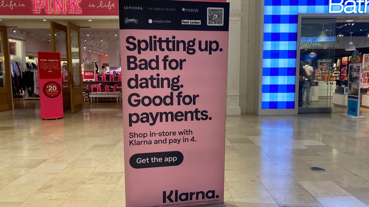 A Klarna promotional sign is seen in a mall