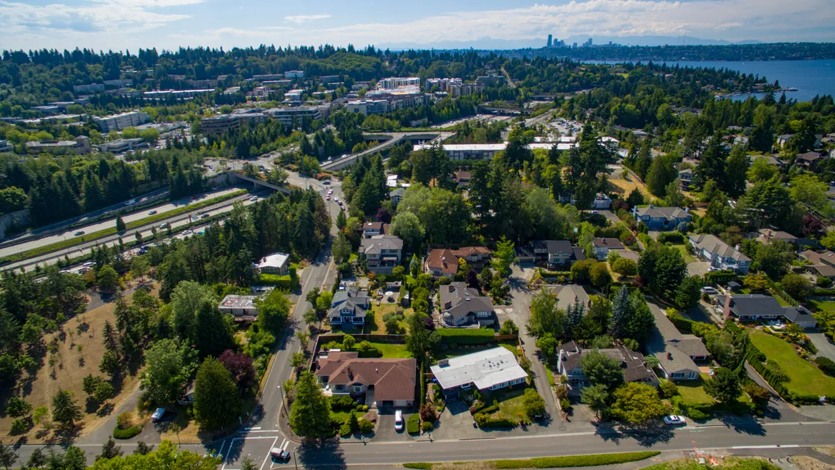 An aerial view of Mercer Island, Washington, and Interstate 90, with the Seattle skyline in the background.