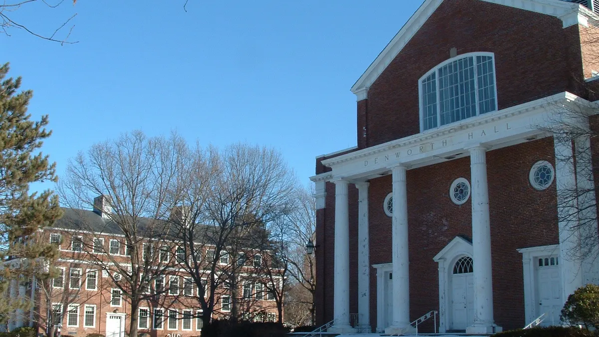 Brick chapel style building with snow on the ground in foreground.