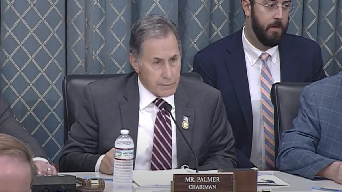 A man sits at a podium
