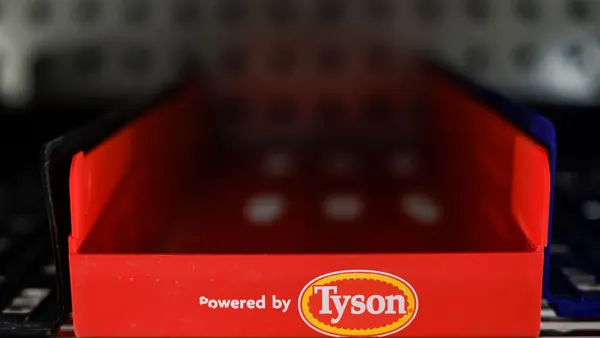 An empty Tyson food holder sits empty in a refrigerated grocery aisle