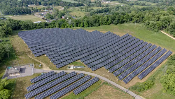 An aerial view of solar panels in a field.