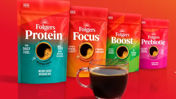 Four bags of Folgers functional coffee are lined up behind a cup of coffee.