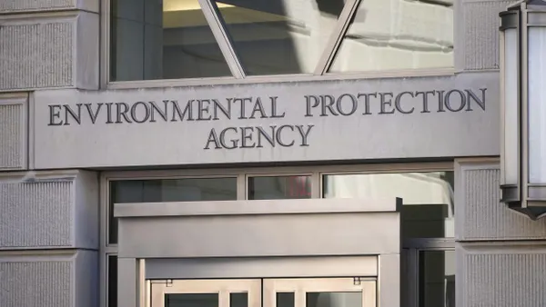 Entrance to a neoclassical building facade that reads "Environmental Protection Agency. "