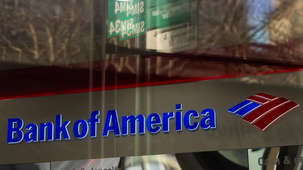 Bank of America signage is shown with a reflection in the glass above it