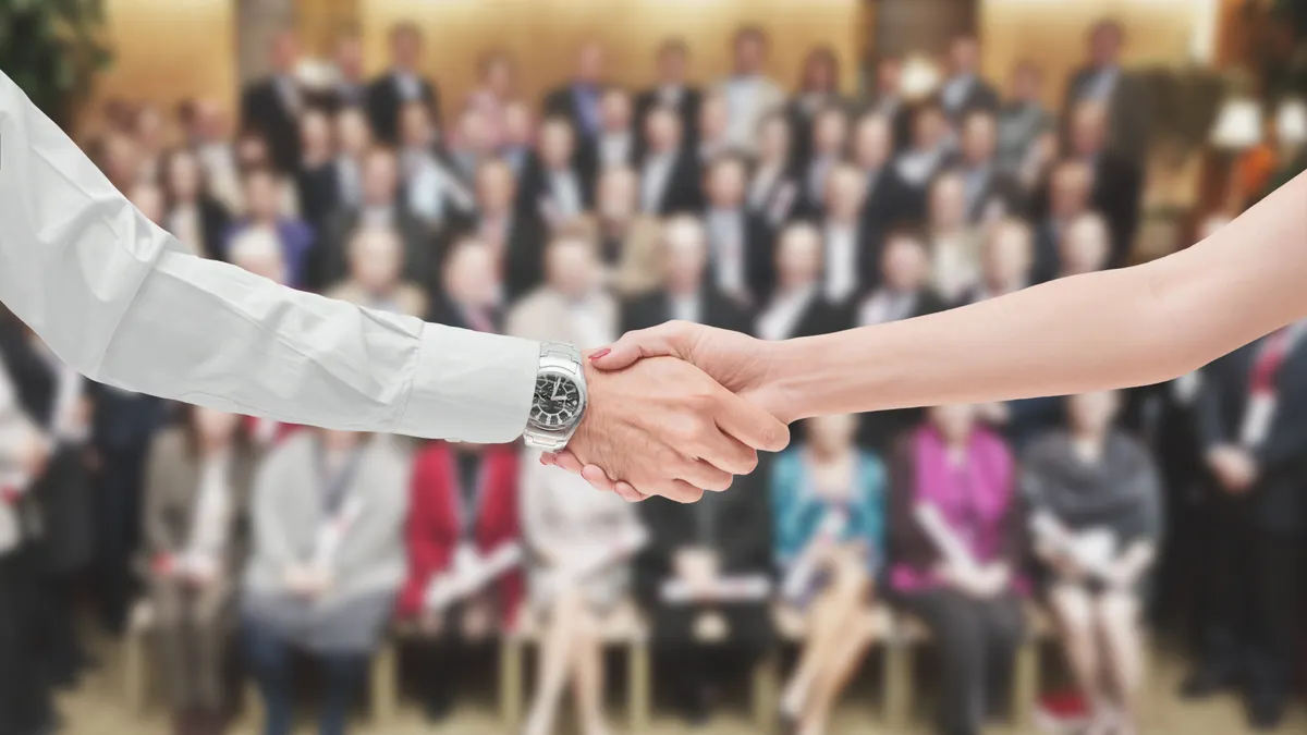 A man and a woman shaking hands