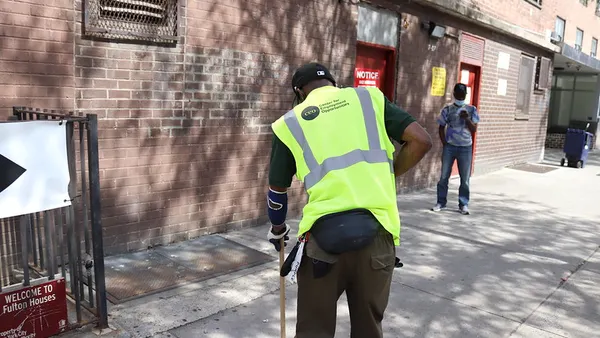 Center for Employment Opportunities worker sweeps New York City street