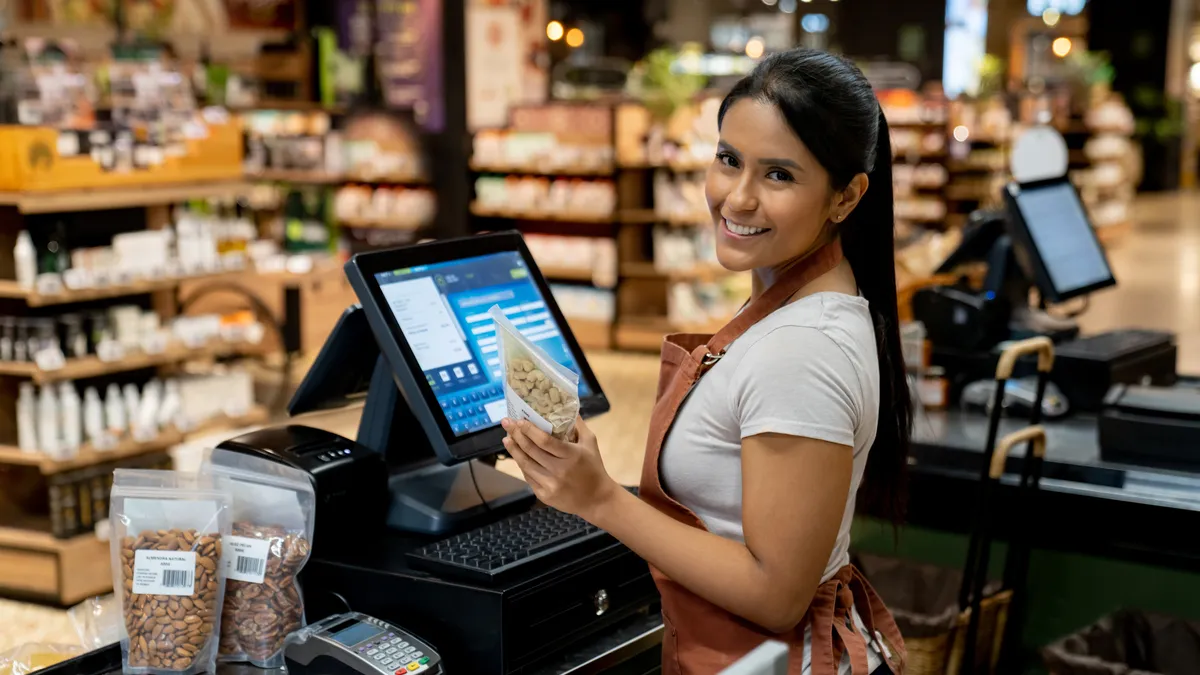 Cashier working at the supermarket registering products