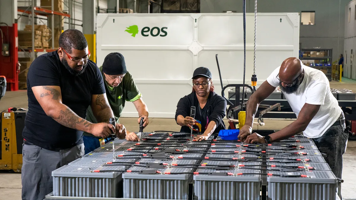 Shadeed Acie, Sam Haidle, Celeste Washington and Denny McDonald assembling a tray for an Eos energy block.