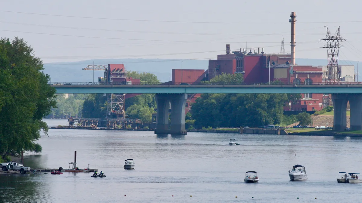 Boats on the Connecticut River, with MIRA facility in background