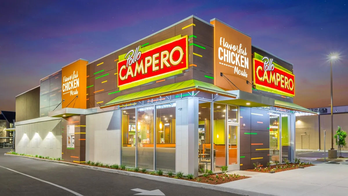 An image of a building with yellow and red stripes. Signage says "Pollo Campero."