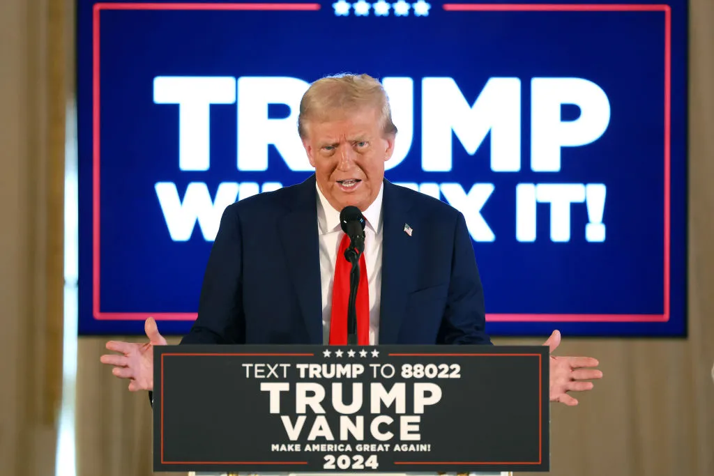 Donald Trump stands in front of a podium at an October press conference.