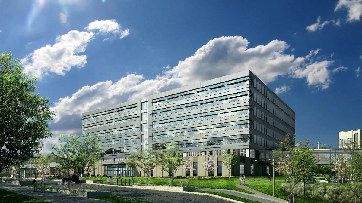 A rendering of a tall office building made of grey stone with a blue sky in the background, and a parking area in the foreground.