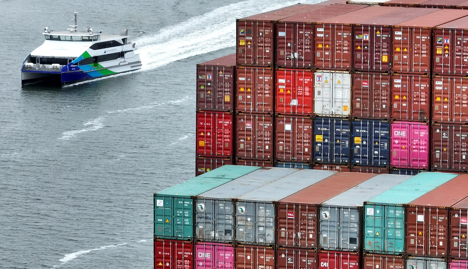 Shipping containers are seen stacked on a ship docked at the Port of Oakland.