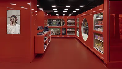 A store with red walls, red shelves and a red floor.