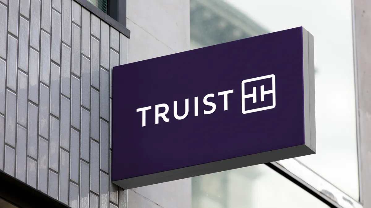 A purple and white sign featuring the Truist logo.