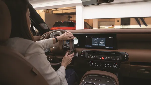 A driver uses the Hyundai myQ Connected Garage in a Hyundai Palisade SUV.