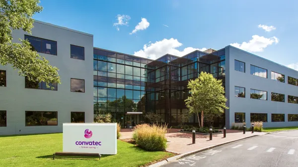 Convatec's Boston facility is shown with a blue sky above.