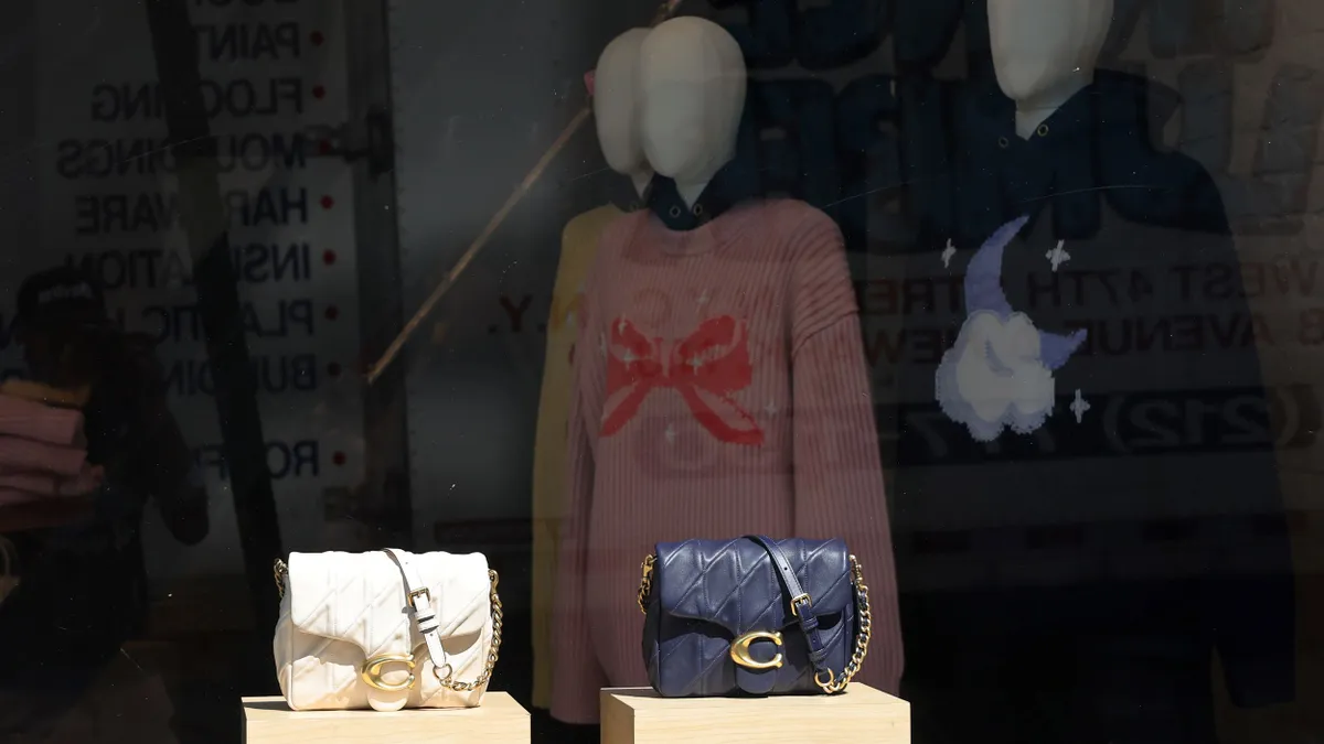 A window display of a Coach store.