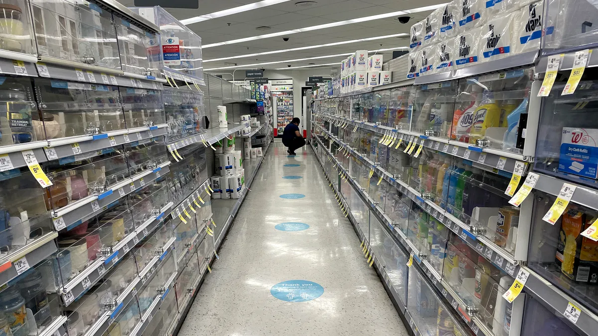 Items are locked behind cabinets in a Walgreens aisle