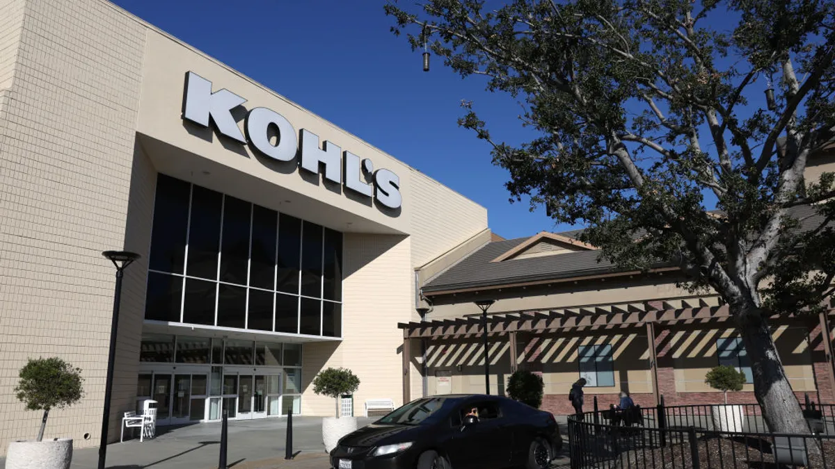 The front of a Kohl's store featuring signage against a nature backdrop.