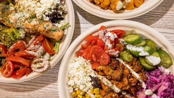 A close up photograph of several bowls with food from Roti Modern Mediterranean