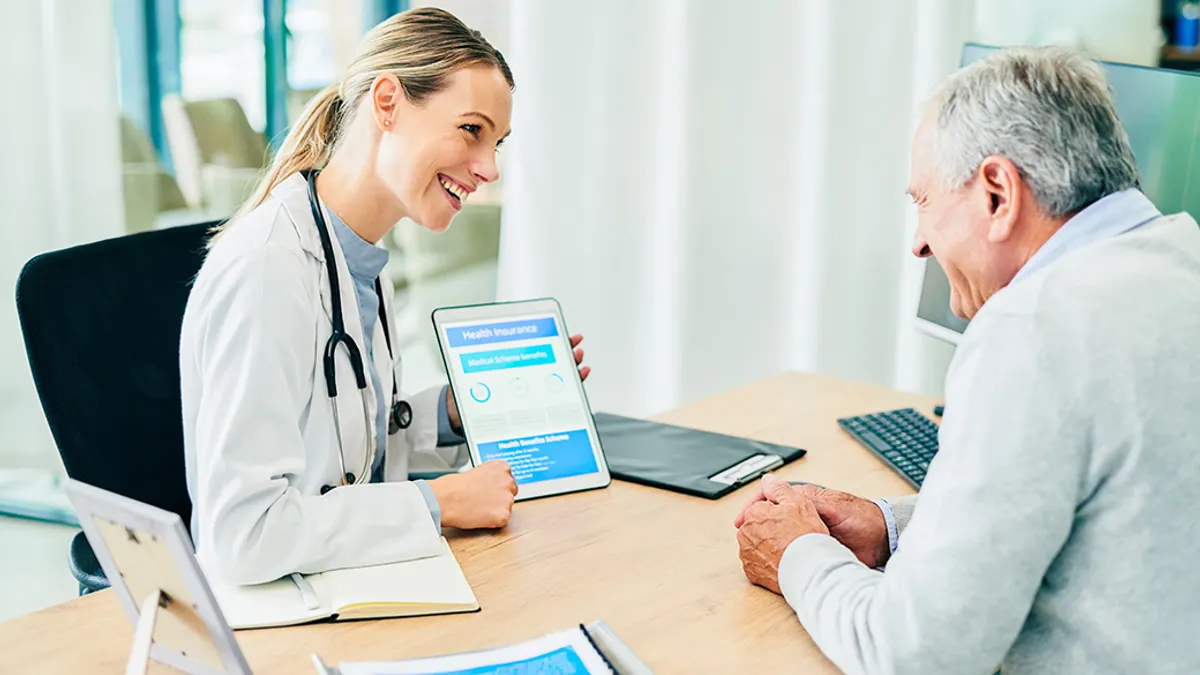 Doctor with tablet talking to patient