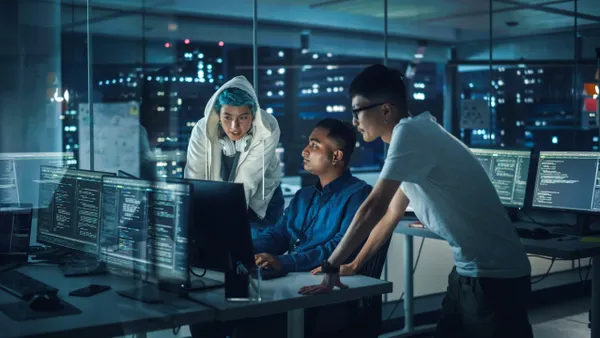 Team of professionals meeting in office around computers