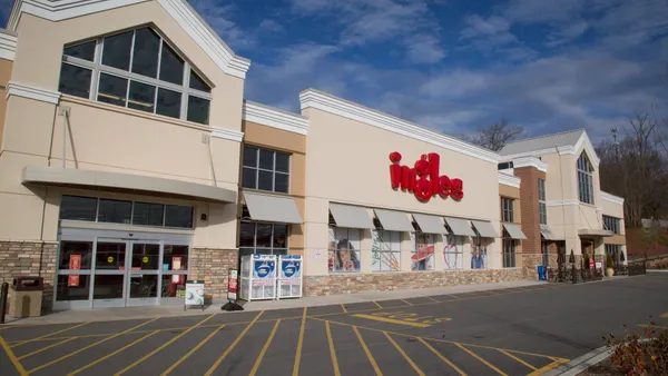 Exterior of a supermarket with a sign that says "ingles" in red letters.